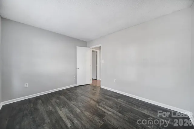 a view of an empty room and wooden floor
