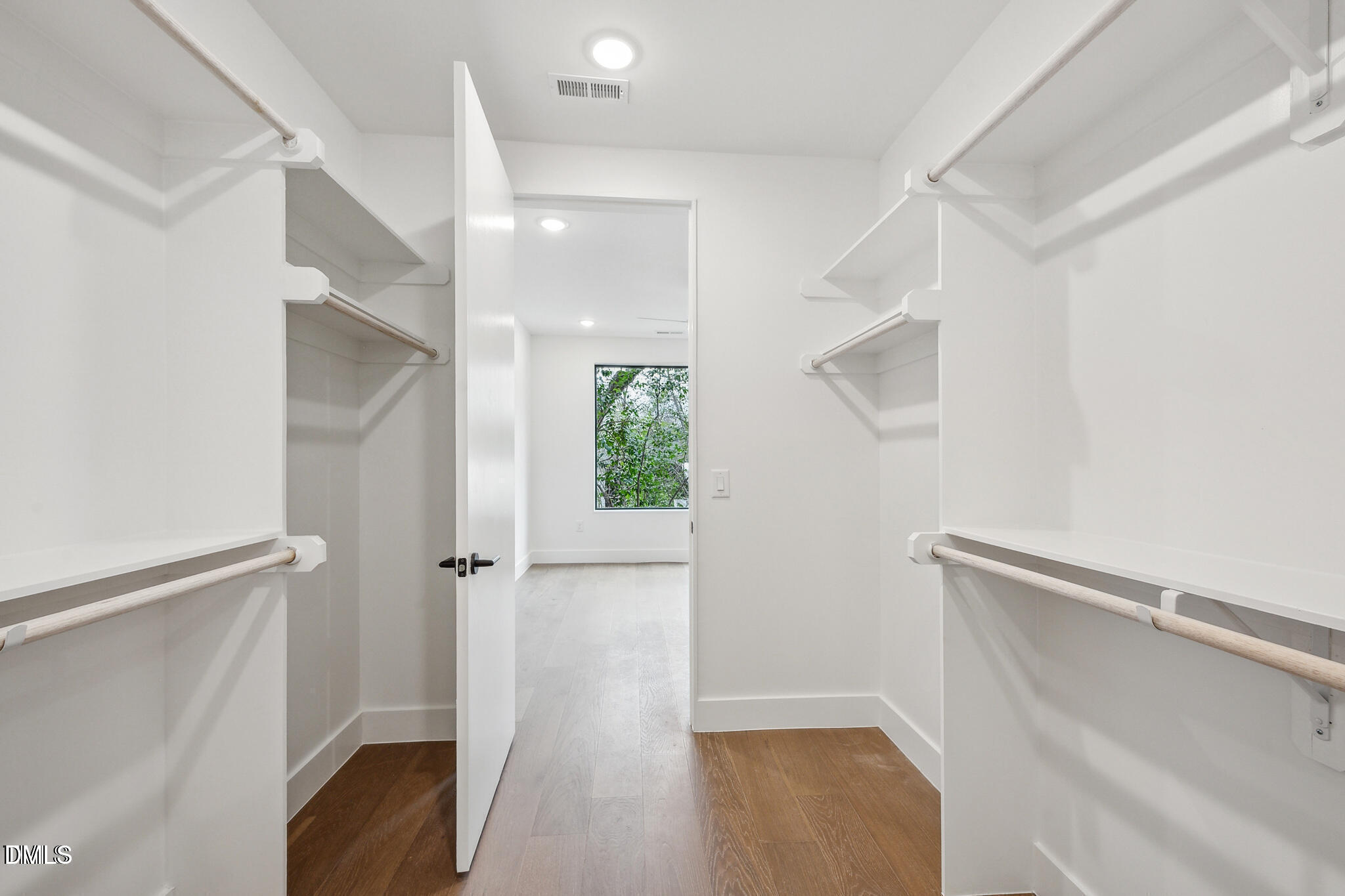 29 Enterprise Street, Unit 109 Raleigh, NC 27607 - Photo 11 of 18 a view of walk in closet with empty racks