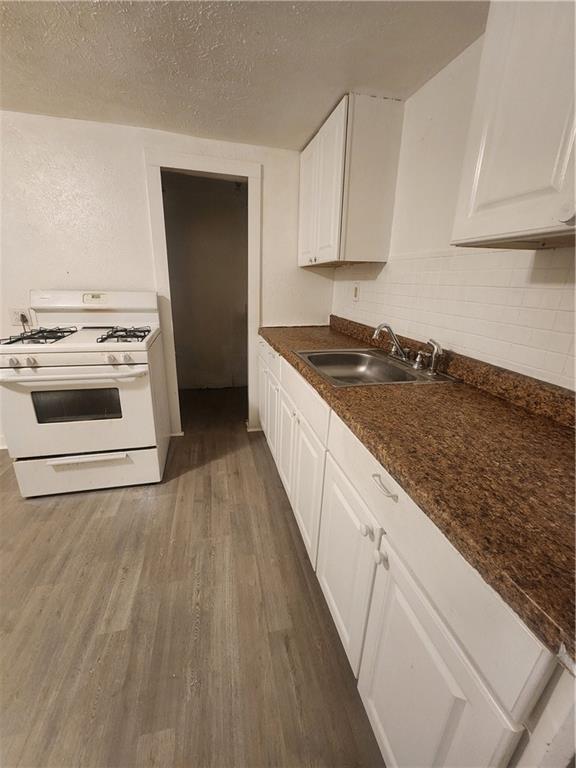 709 Camp Street McKees Rocks, PA 15136 - Photo 4 of 9 a kitchen with granite countertop white cabinets and white appliances