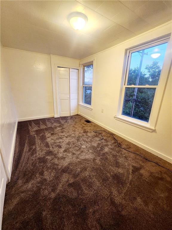 709 Camp Street McKees Rocks, PA 15136 - Photo 8 of 9 a view of an empty room with a window and wooden floor