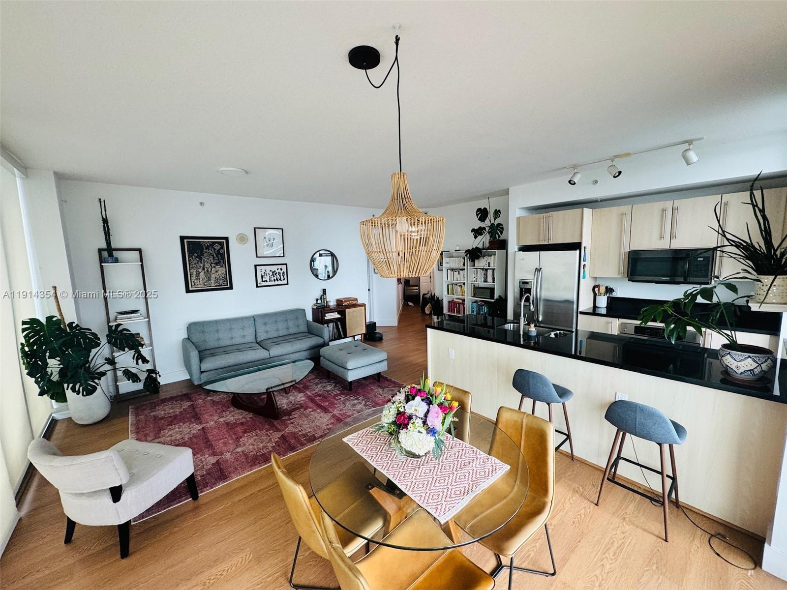 a living room with furniture and kitchen view