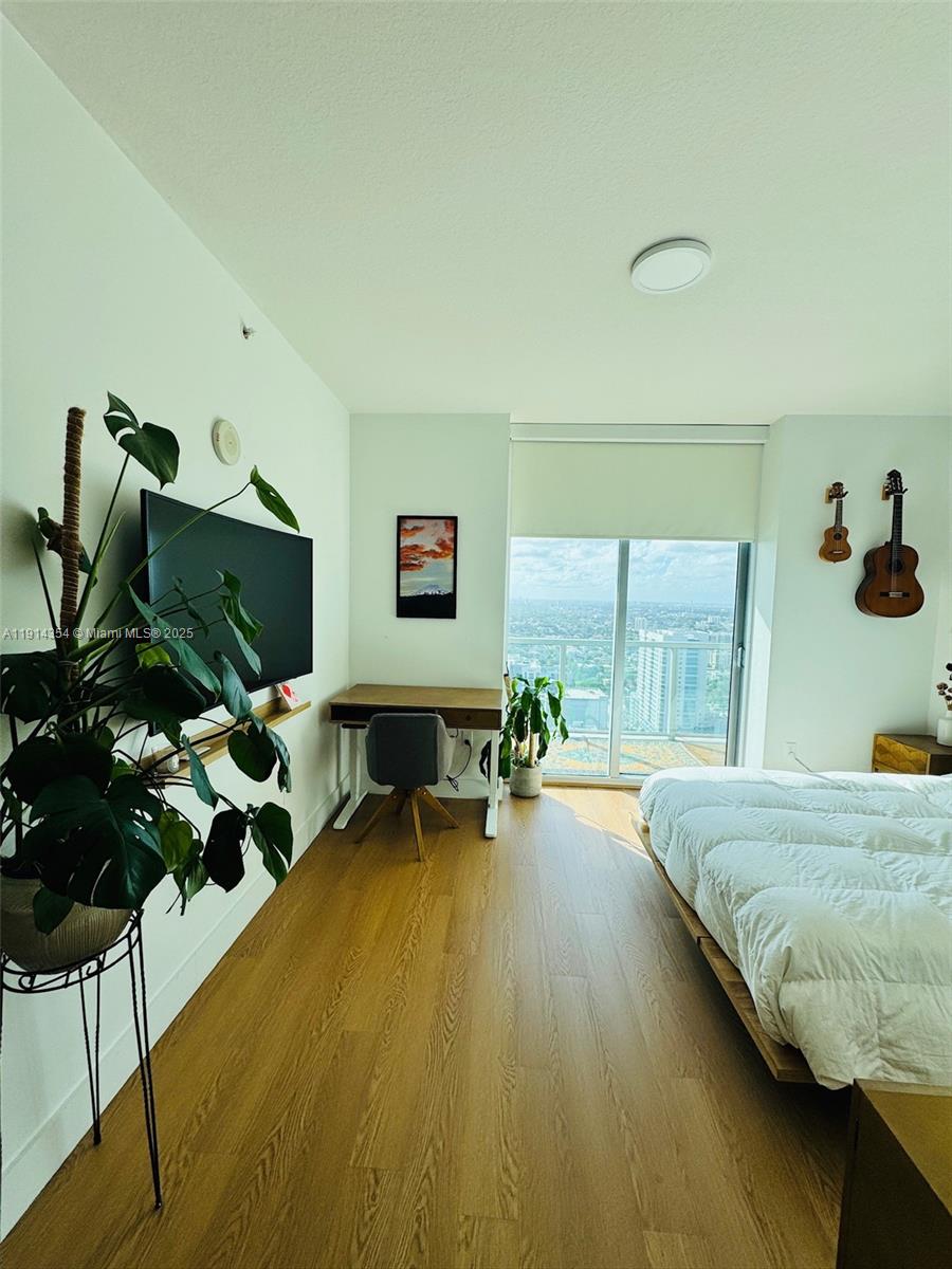 79 Southwest 12th Street, Unit 3601S Miami, FL 33130 - Photo 11 of 27 a bedroom with bed and glass door