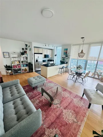 a living room with furniture and kitchen view
