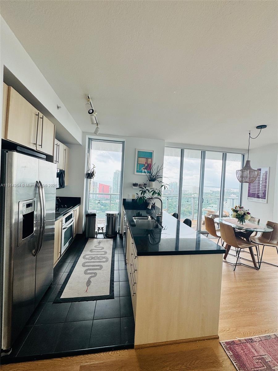 79 Southwest 12th Street, Unit 3601S Miami, FL 33130 - Photo 8 of 27 a living room with fireplace furniture and a floor to ceiling window