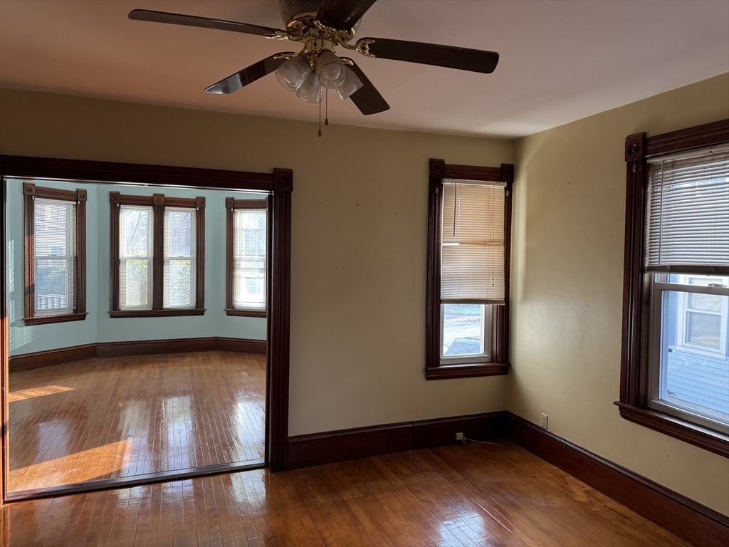 93 Cross Street Gardner, MA 01440 - Photo 12 of 35 a view of an empty room with wooden floor and a window