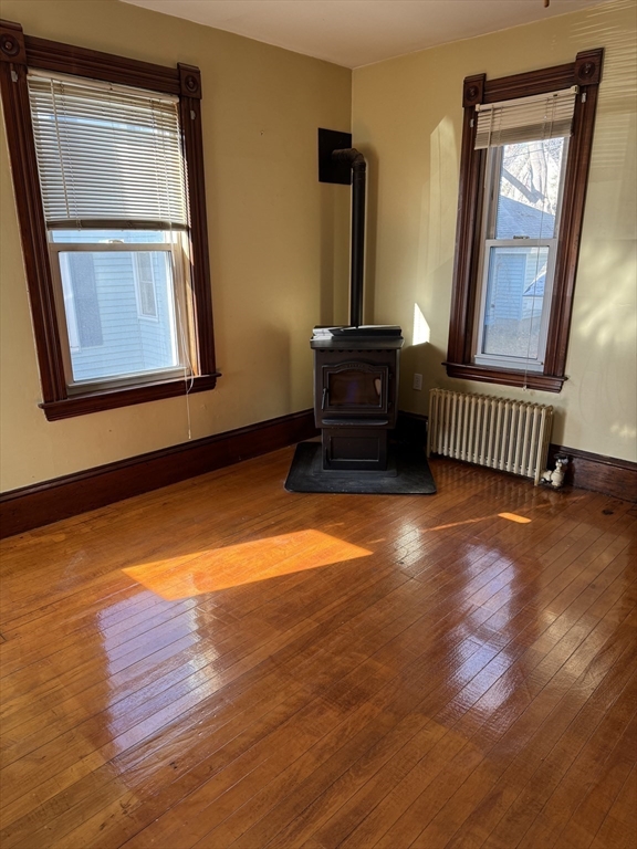 93 Cross Street Gardner, MA 01440 - Photo 14 of 35 a view of empty room with window and wooden floor