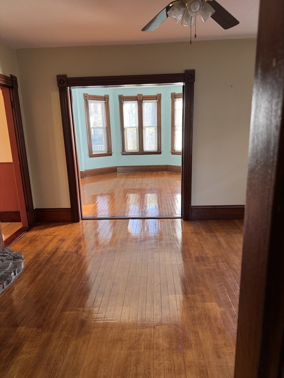 93 Cross Street Gardner, MA 01440 - Photo 19 of 35 a view of an empty room with wooden floor and a window