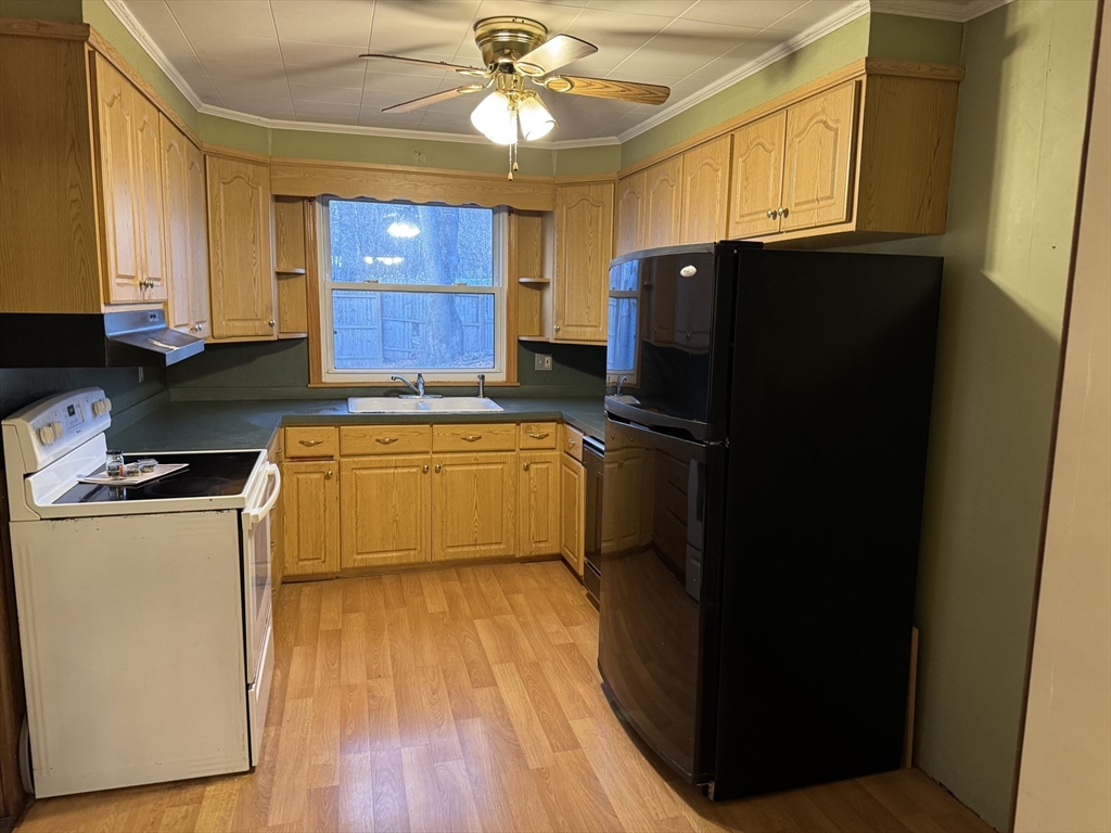93 Cross Street Gardner, MA 01440 - Photo 20 of 35 a kitchen with a refrigerator a stove top oven a sink and dishwasher with wooden floor