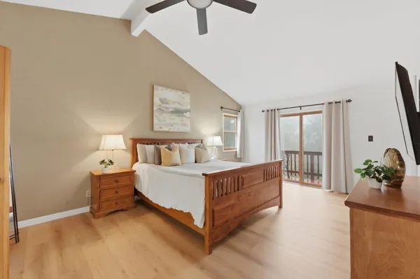 a bed room with a bed and a flat tv screen