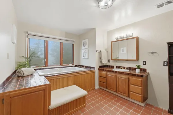 a bathroom with a double vanity sink toilet and shower