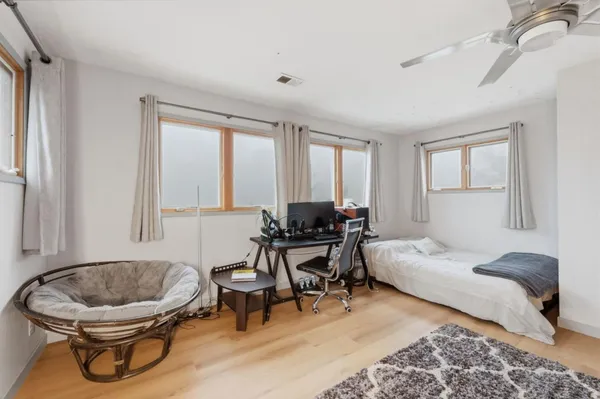 a bedroom with bed and window