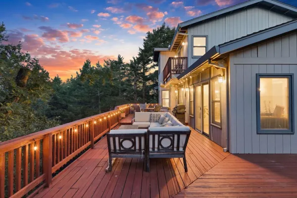 a view of balcony with deck wooden floor and outdoor seating