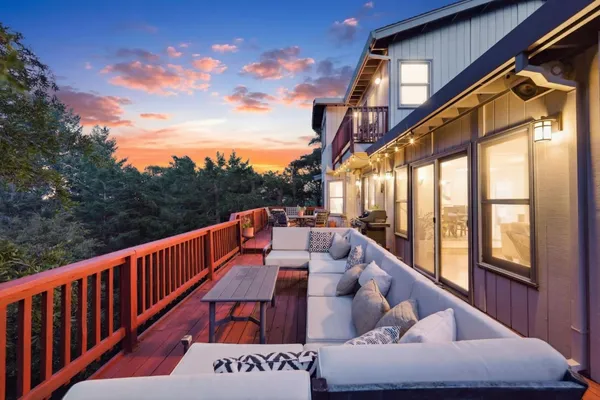 a backyard of a house with a yard and outdoor seating