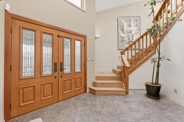 a view of entryway and hall with dining room and stairs