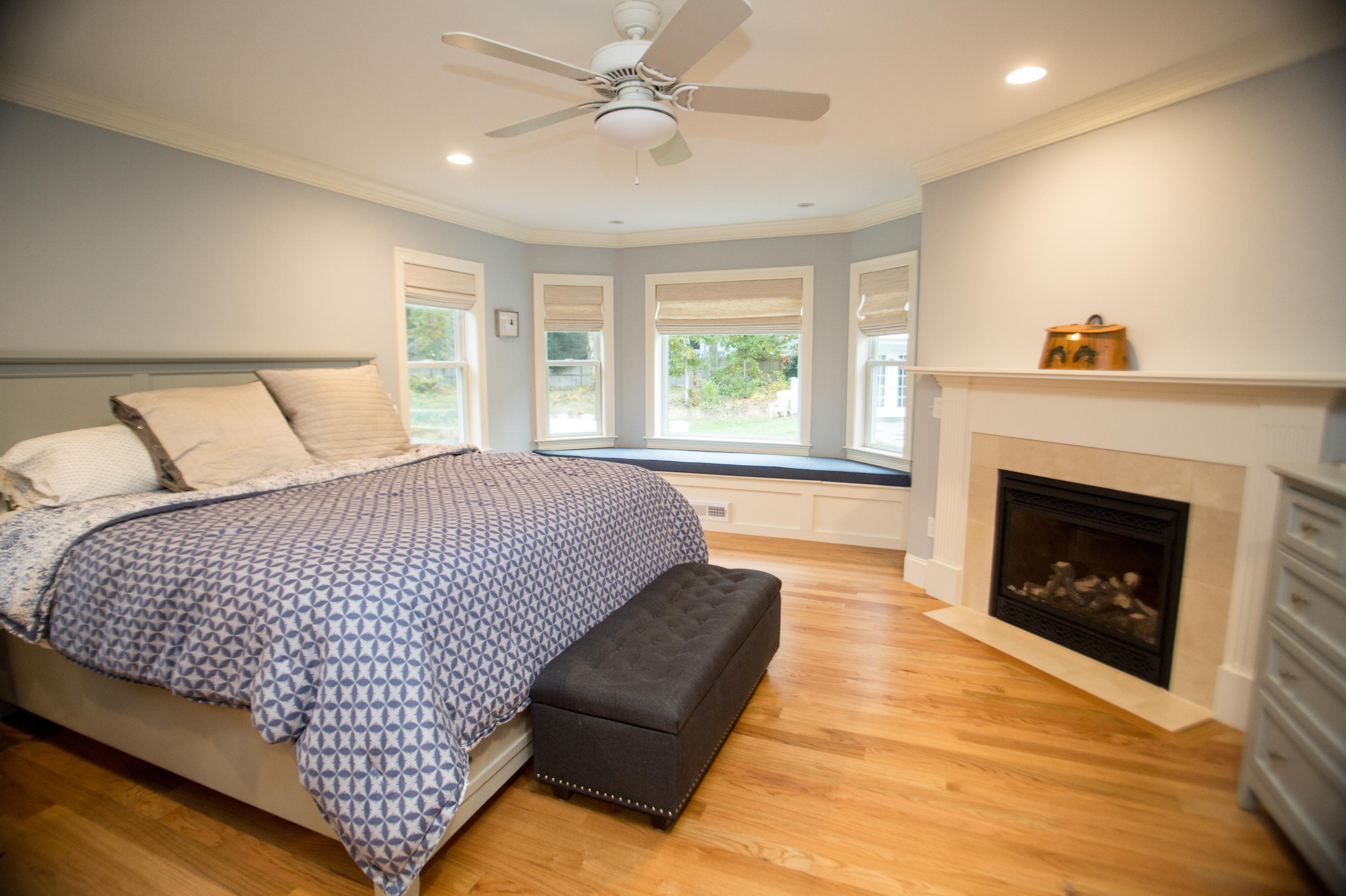 15 Center Lane Centerville, MA 02632 - Photo 16 of 36 a spacious bedroom with a bed and a fireplace
