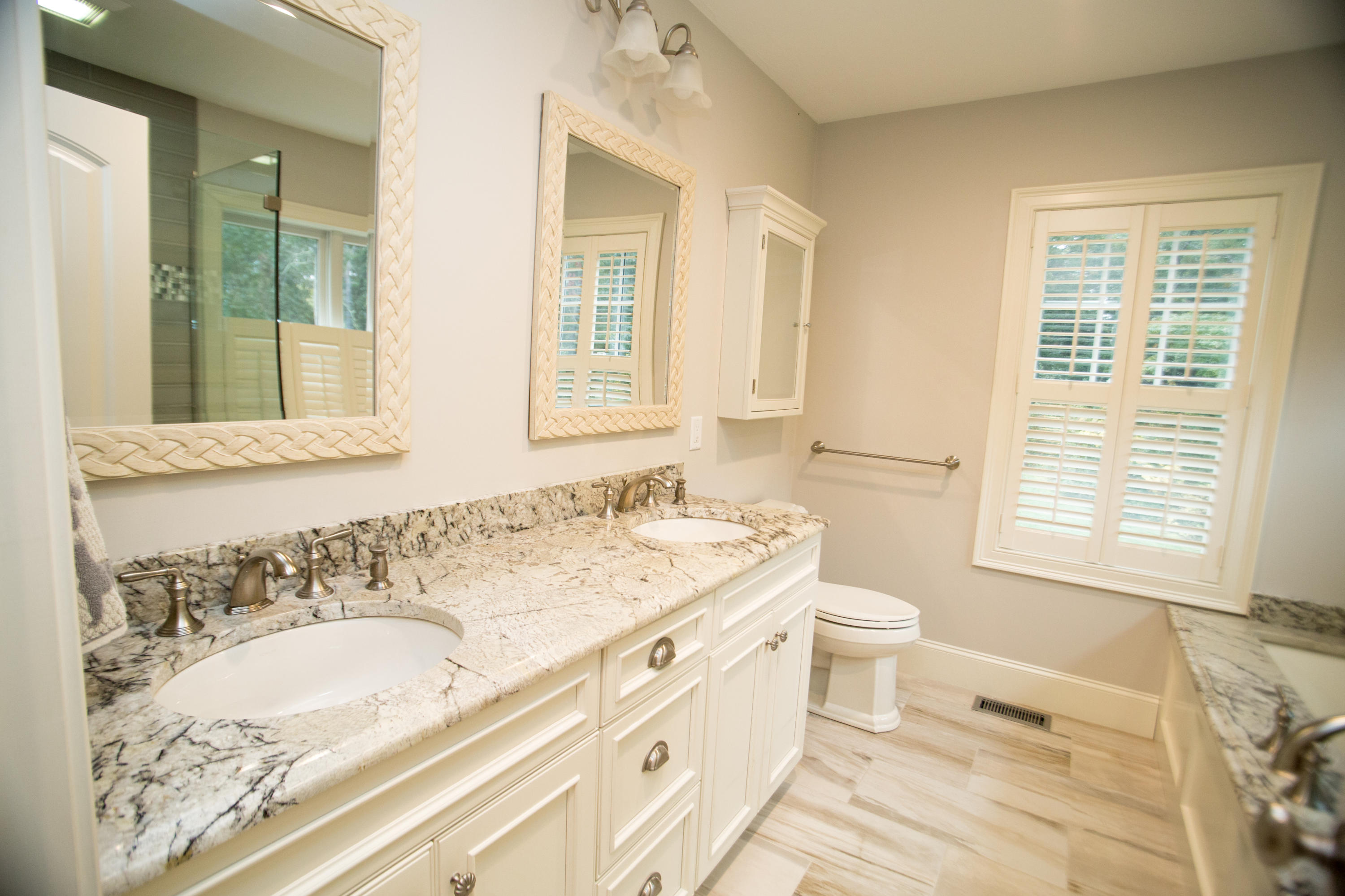 15 Center Lane Centerville, MA 02632 - Photo 18 of 36 a bathroom with a granite countertop toilet a sink and a bathtub