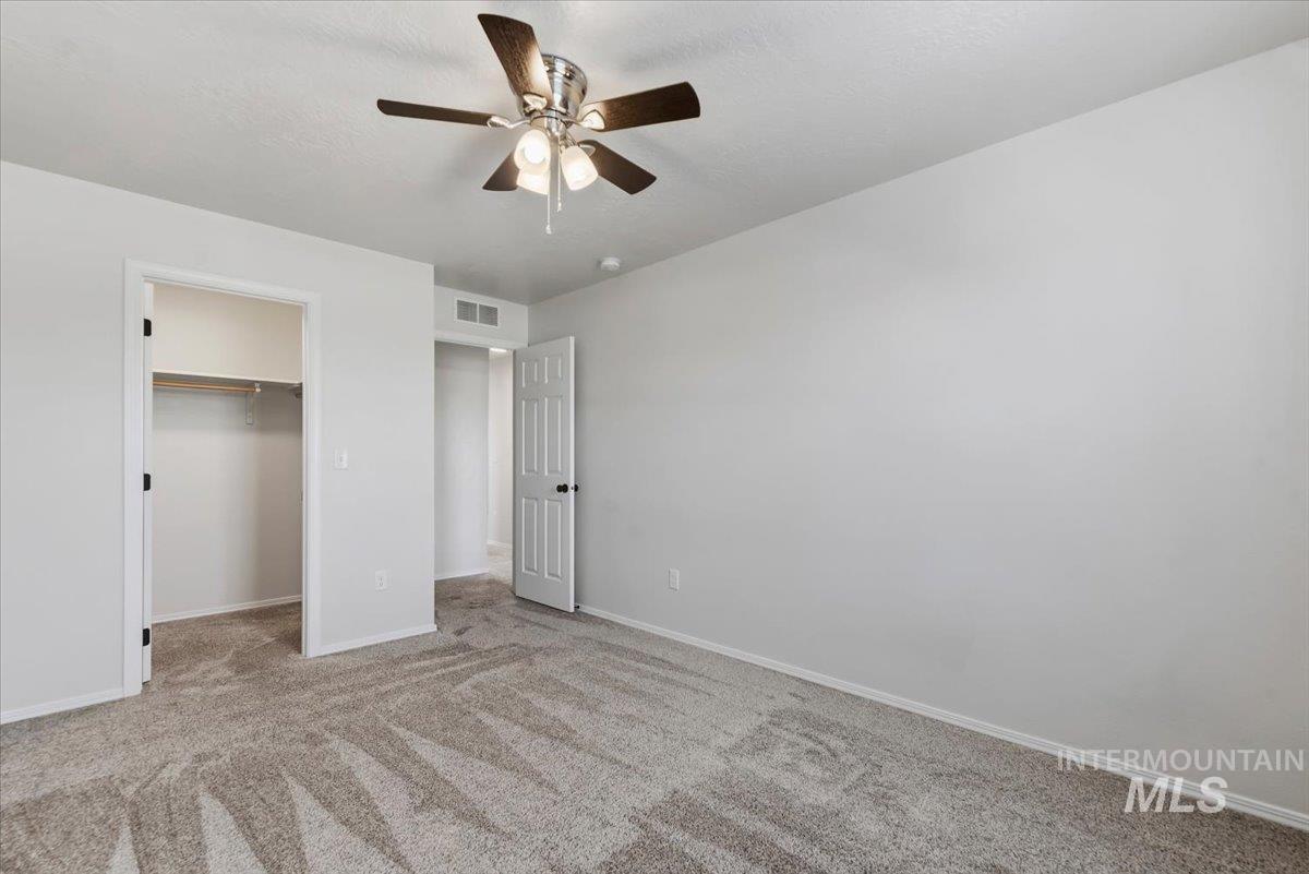 12310 West Hidden Point Drive Star, ID 83669 - Photo 23 of 48 Neutral-toned carpeting and light-colored walls define this room