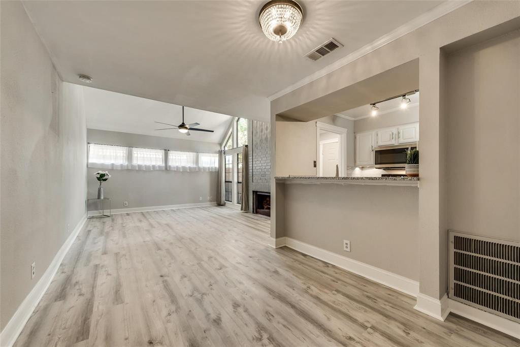 18240 Midway Road, Unit 302 Dallas, TX 75287 - Photo 7 of 33 an empty room with wooden floor and windows