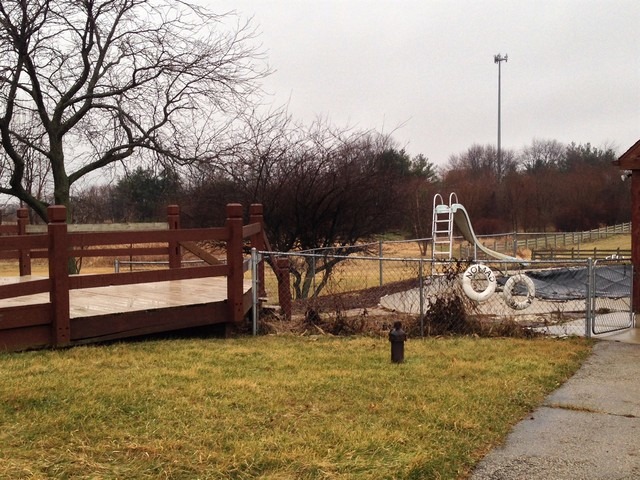 19N310 Boyer Road Algonquin, IL 60102 - Photo 17 of 25 a view of a swimming pool with a bench and wooden fence
