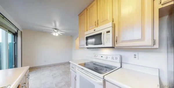 a kitchen with stainless steel appliances granite countertop a sink and a microwave