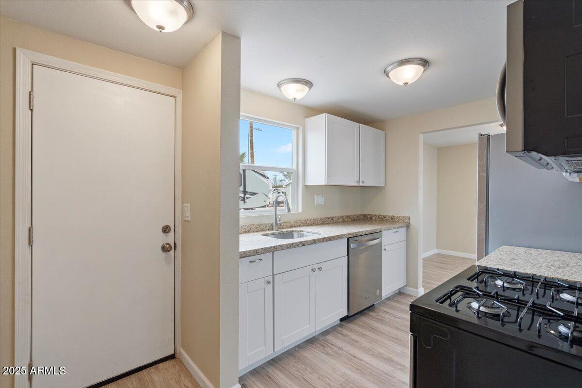 320 East McKellips Road, Unit 209 Mesa, AZ 85201 - Photo 14 of 25 a kitchen with stainless steel appliances a sink stove and refrigerator