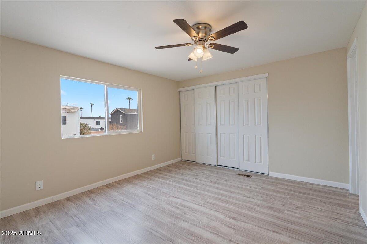 320 East McKellips Road, Unit 209 Mesa, AZ 85201 - Photo 16 of 25 a view of empty room with wooden floor and window