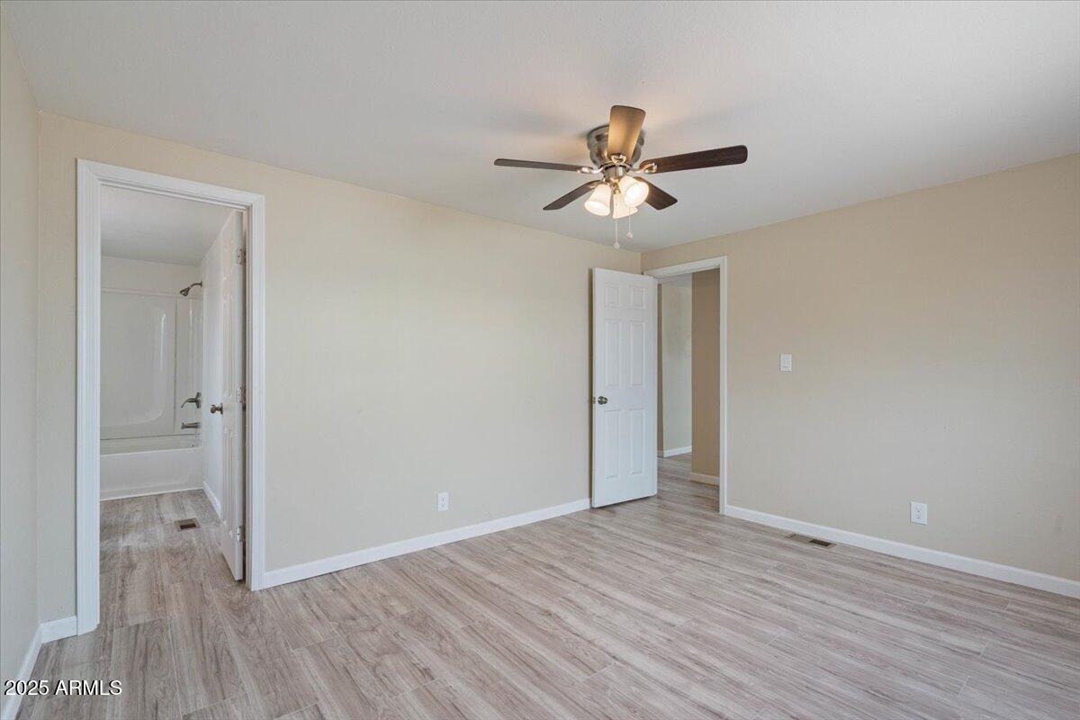 320 East McKellips Road, Unit 209 Mesa, AZ 85201 - Photo 17 of 25 a view of empty room with wooden floor and ceiling fan