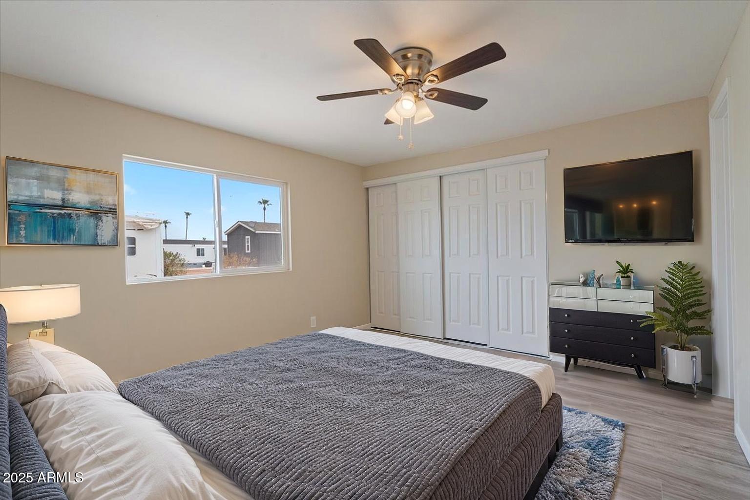 320 East McKellips Road, Unit 209 Mesa, AZ 85201 - Photo 2 of 25 a bedroom with a bed and a flat screen tv