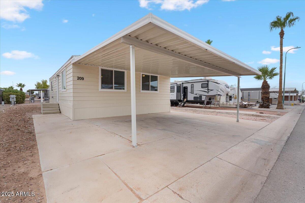 320 East McKellips Road, Unit 209 Mesa, AZ 85201 - Photo 5 of 25 a garage with view of the house