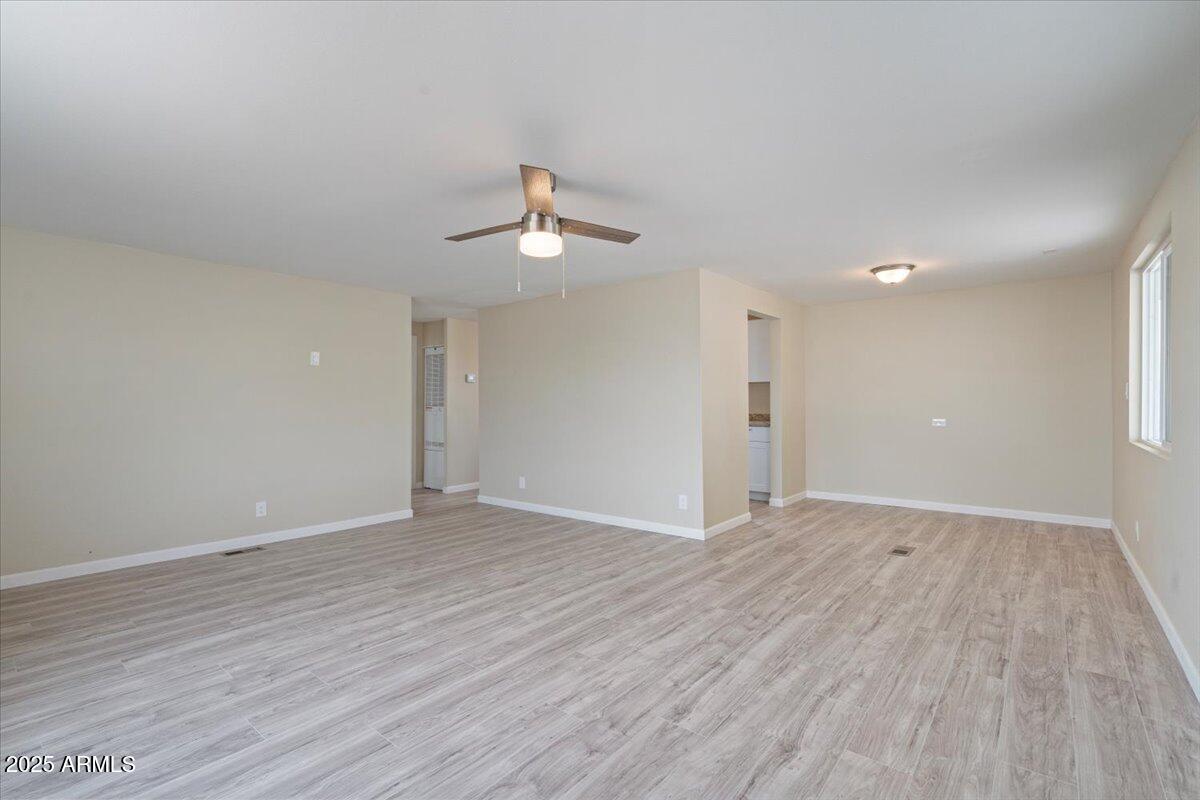 320 East McKellips Road, Unit 209 Mesa, AZ 85201 - Photo 10 of 25 wooden floor in an empty room with a window