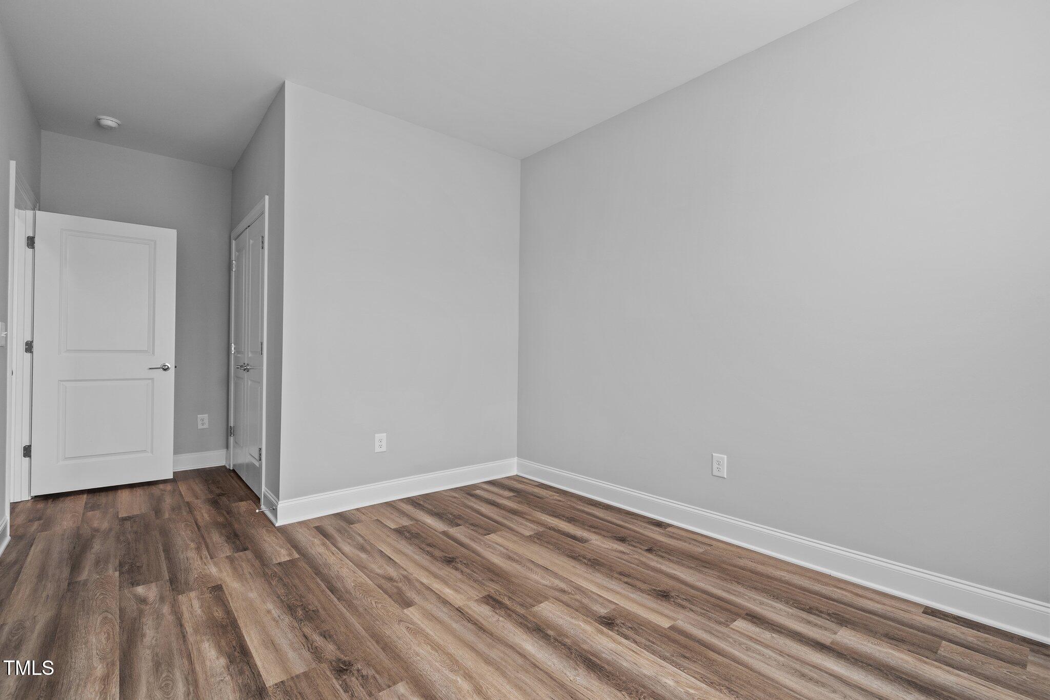 703 Jamescroft Way, Unit 13 Rolesville, NC 27571 - Photo 18 of 36 a view of room with wooden floor