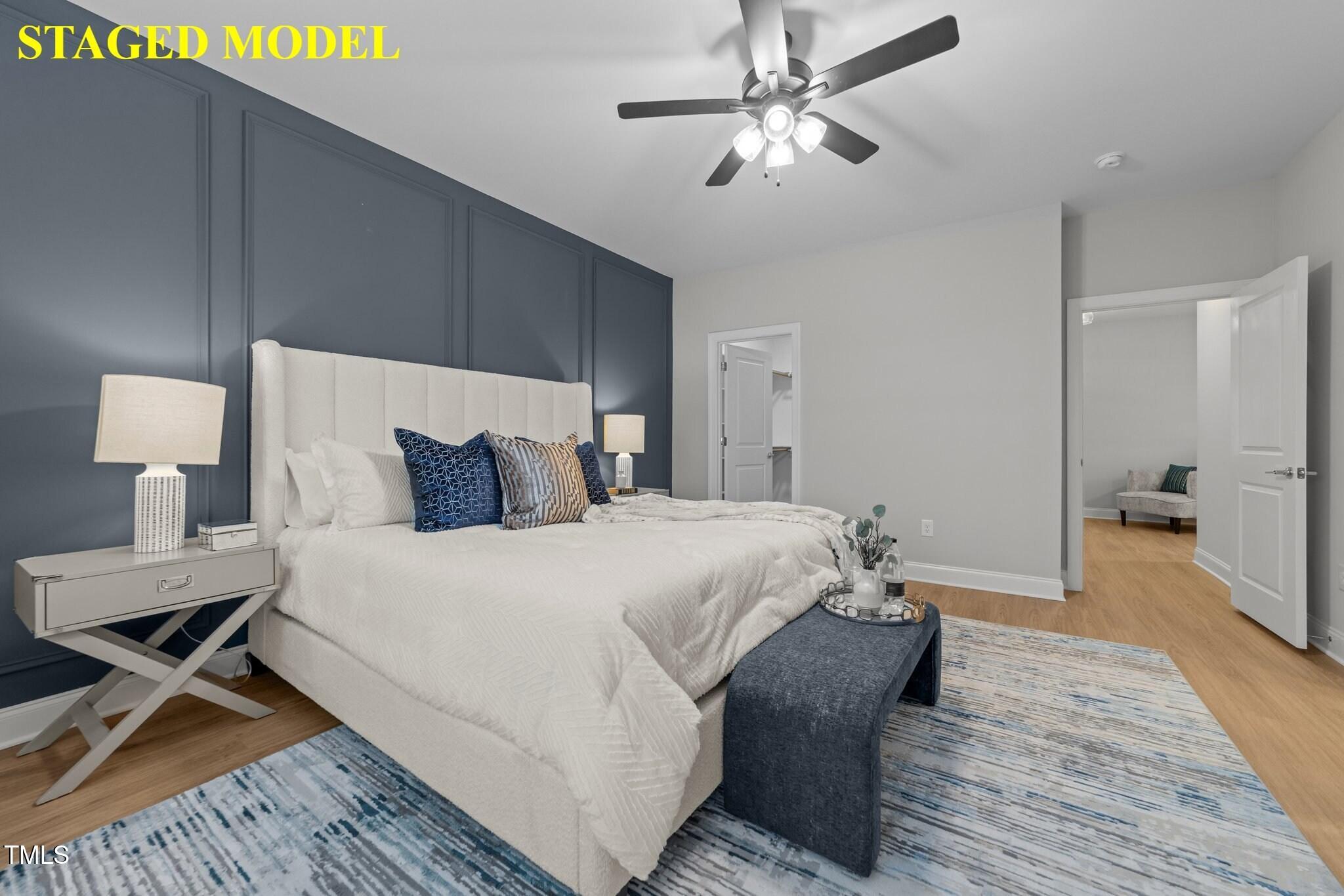 703 Jamescroft Way, Unit 13 Rolesville, NC 27571 - Photo 31 of 36 a bedroom with a bed and a chandelier