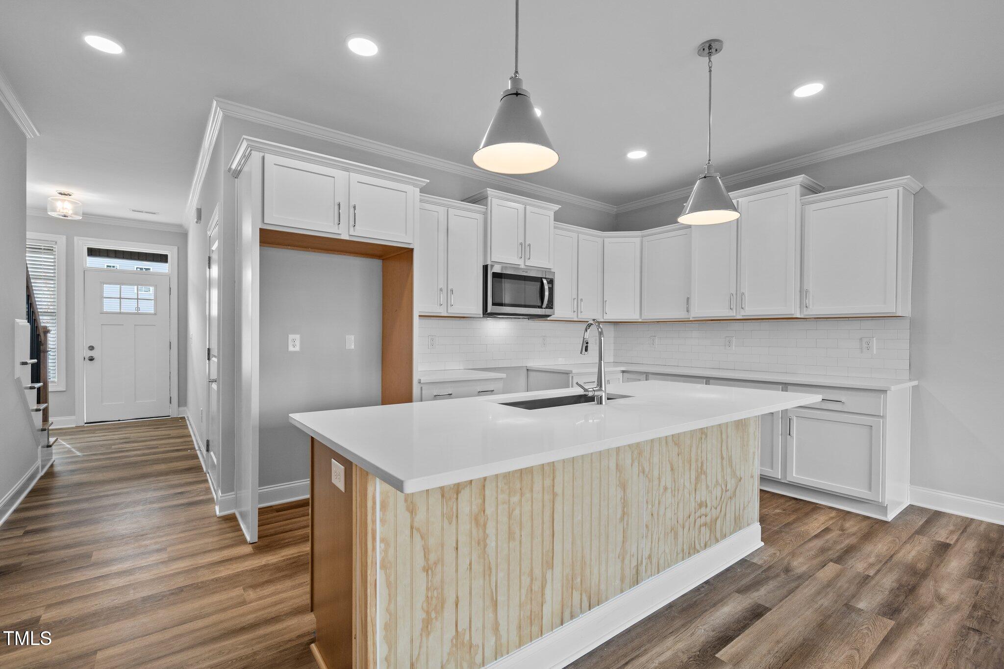 703 Jamescroft Way, Unit 13 Rolesville, NC 27571 - Photo 3 of 36 a kitchen with a sink stainless steel appliances and cabinets