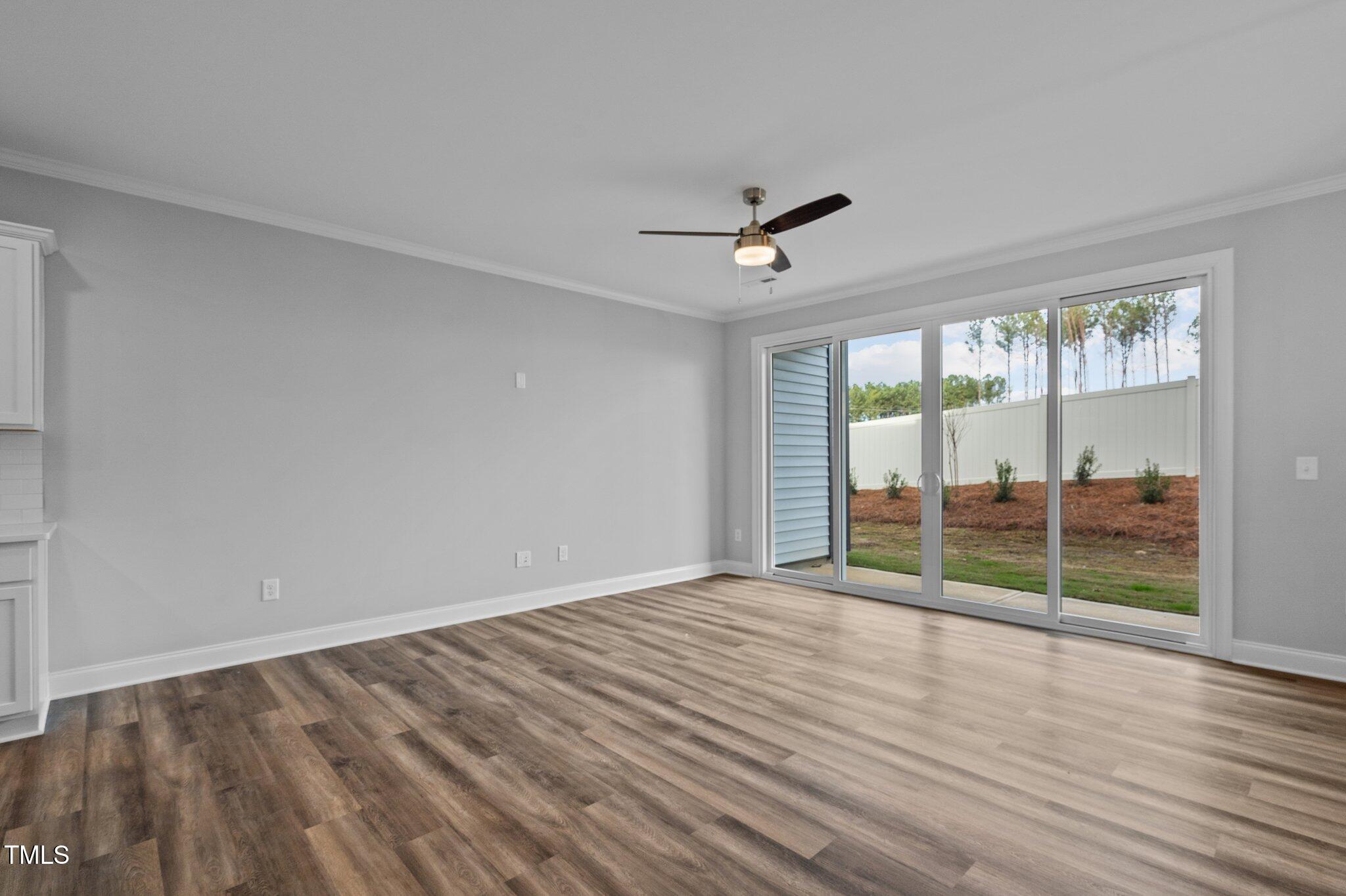 703 Jamescroft Way, Unit 13 Rolesville, NC 27571 - Photo 6 of 36 wooden floor in an empty room with a window