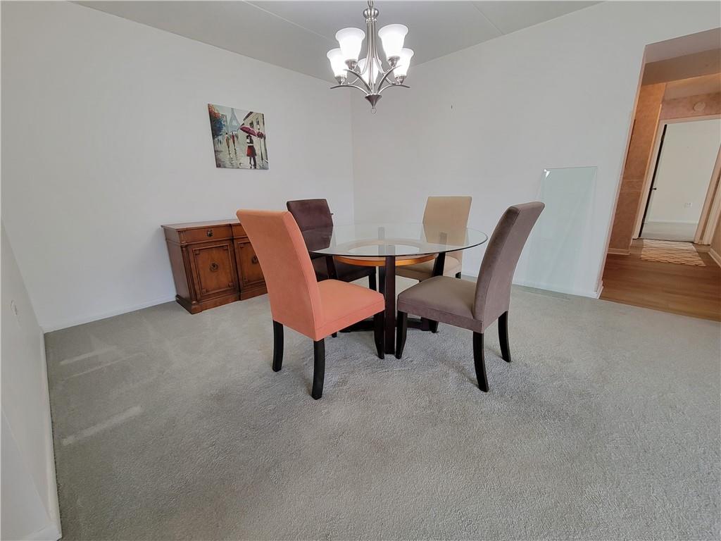 2120 Greentree Road, Unit 100E Pittsburgh, PA 15220 - Photo 5 of 25 a view of a dining room with furniture and a chandelier