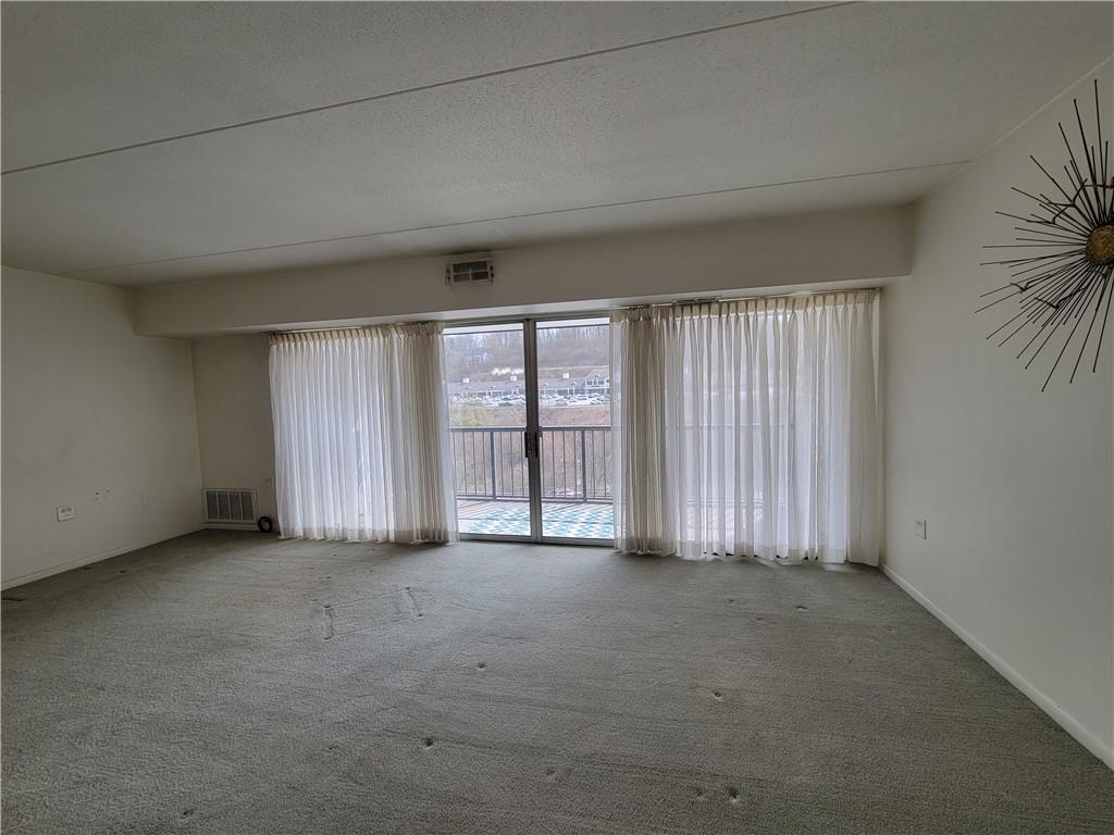 2120 Greentree Road, Unit 100E Pittsburgh, PA 15220 - Photo 6 of 25 an empty room with windows