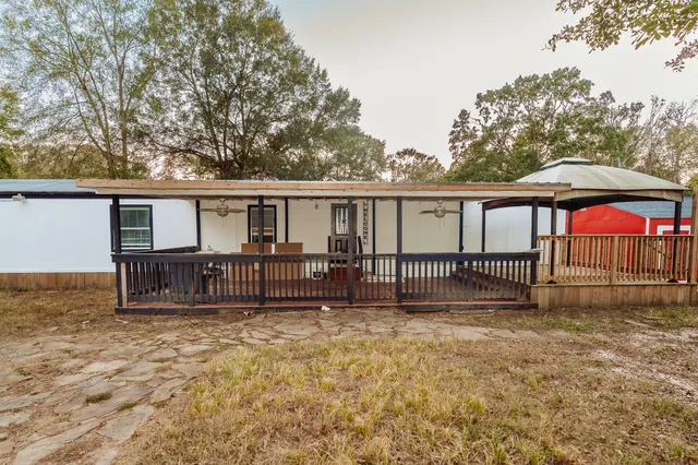 front view of a house with a yard and fence