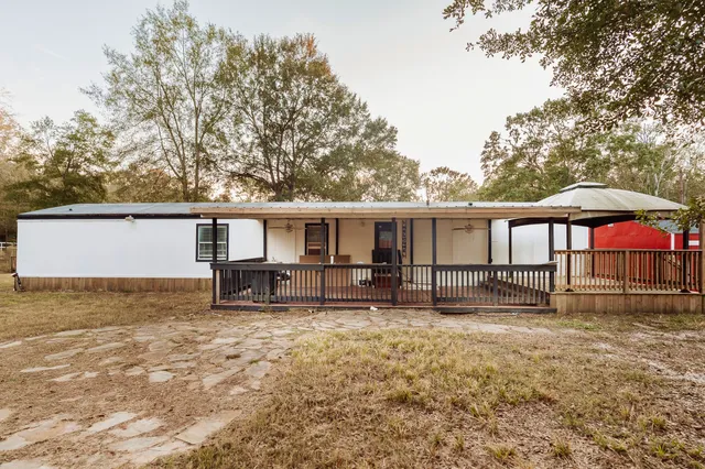 front view of a house with a yard and a table and chairs