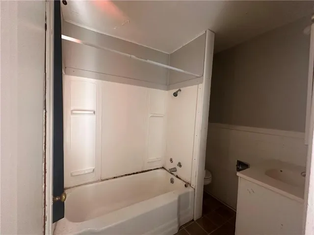 a bathroom with a bathtub and a toilet