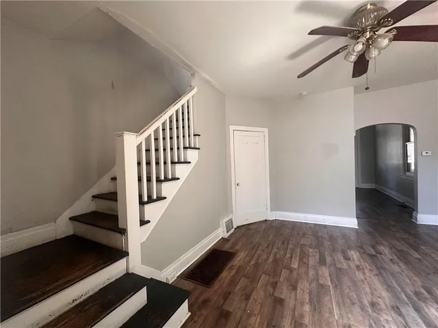 wooden floor in an empty room with a window