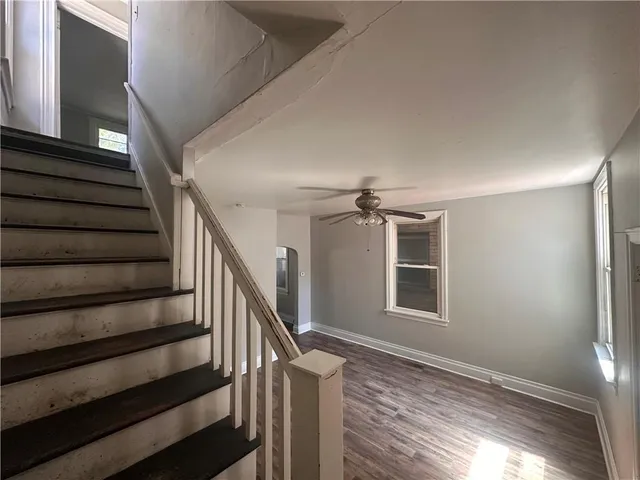 a view of entryway and hall with wooden floor