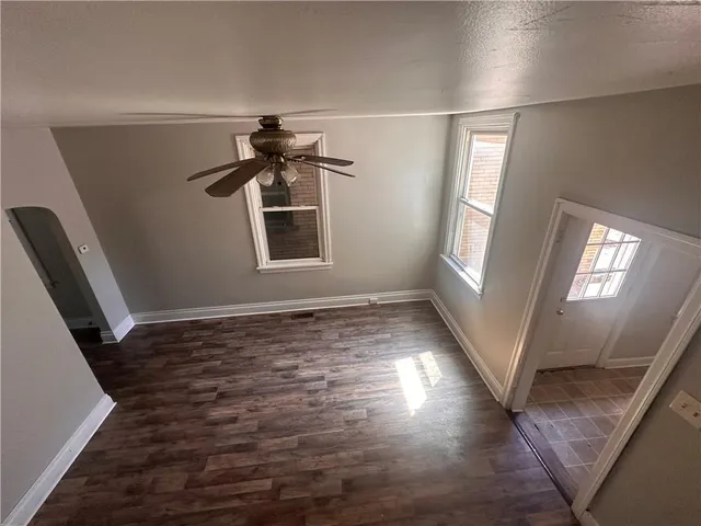 wooden floor in an empty room with a window