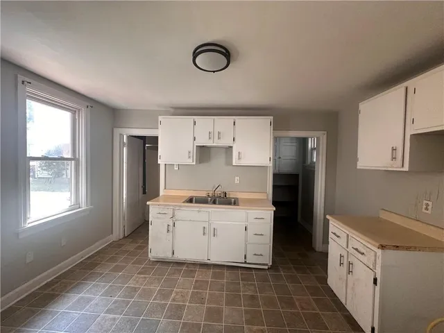 a kitchen with a stove a sink and a refrigerator