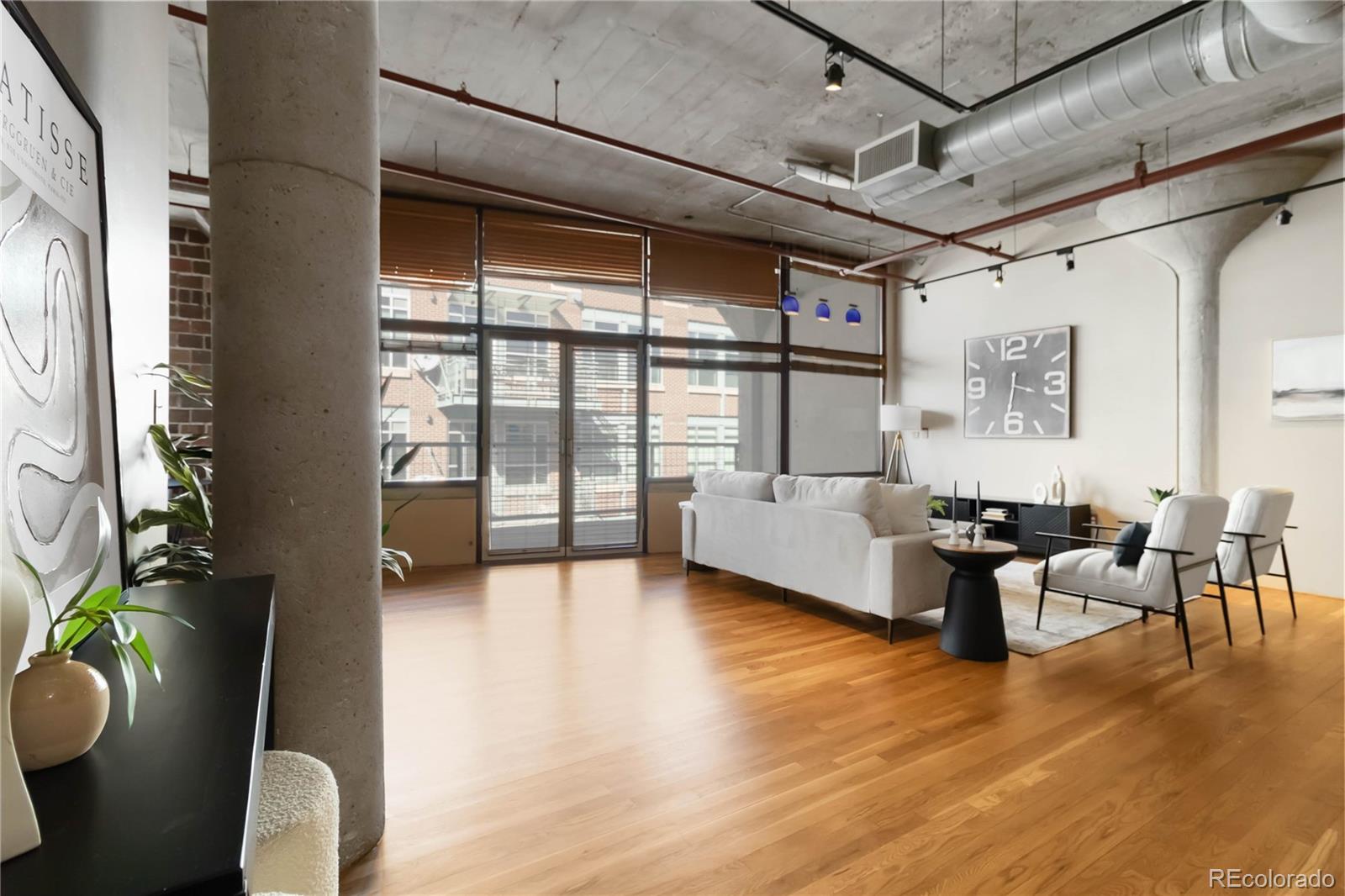 1863 Wazee Street, Unit 6E Denver, CO 80202 - Photo 12 of 49 a living room with furniture and a large window