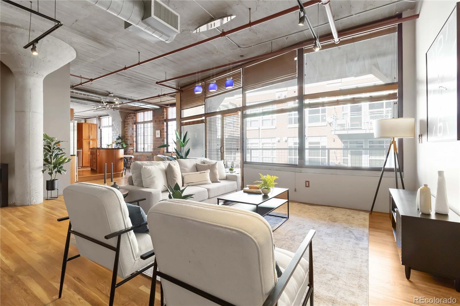 1863 Wazee Street, Unit 6E Denver, CO 80202 - Photo 19 of 49 a living room with furniture and a large window