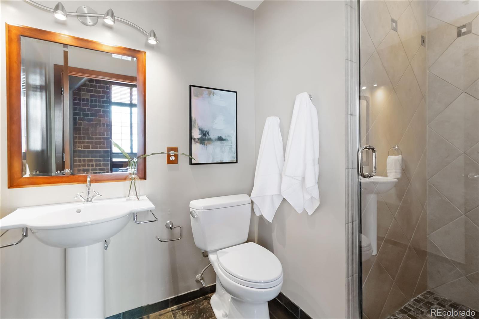 1863 Wazee Street, Unit 6E Denver, CO 80202 - Photo 29 of 49 a bathroom with a sink toilet and shower