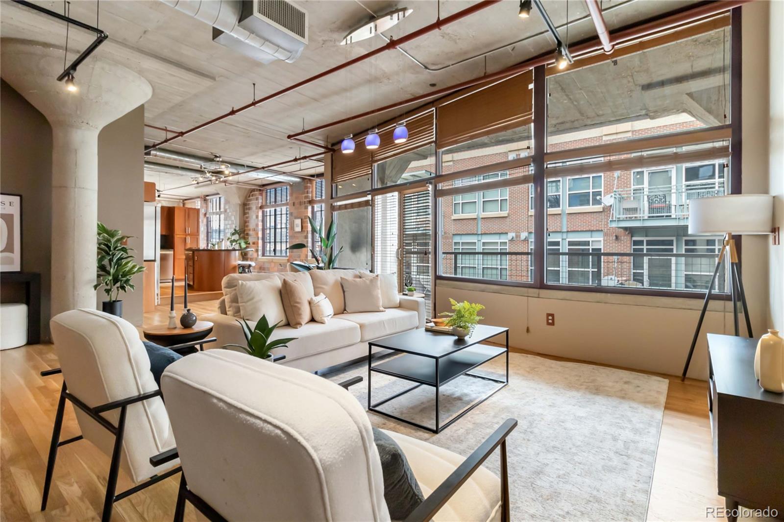1863 Wazee Street, Unit 6E Denver, CO 80202 - Photo 5 of 49 a living room with furniture and a large window