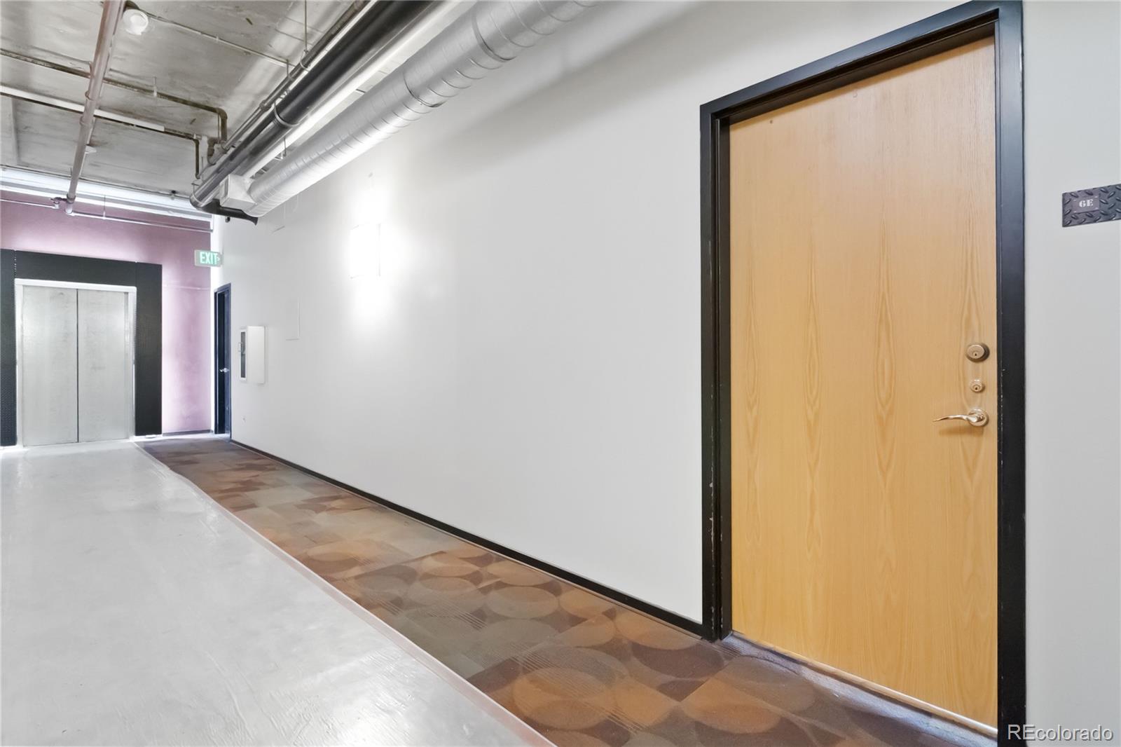 1863 Wazee Street, Unit 6E Denver, CO 80202 - Photo 10 of 49 a view of a hallway with wooden floor and a bathroom
