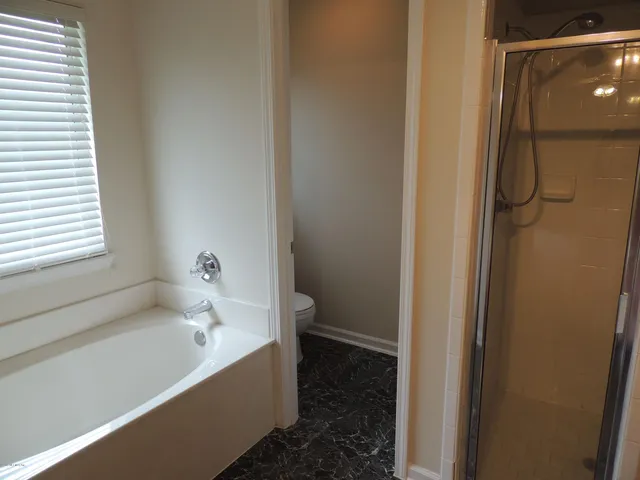 a bathroom with a bathtub and a shower