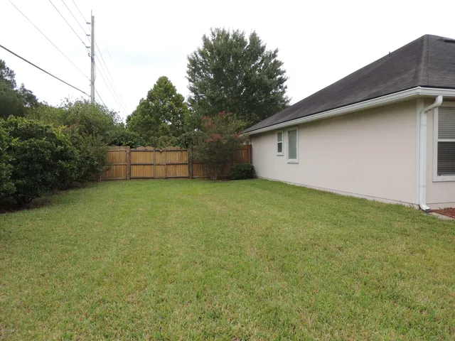 a backyard of a house with lots of green space